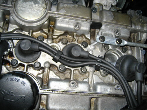 It's dry underneath the spark plug cover.