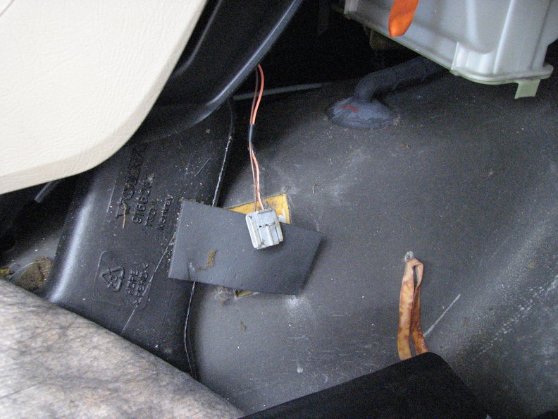 Front passengers side in front of the console.