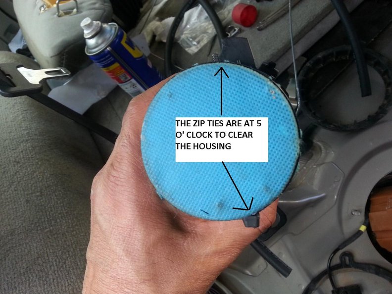 Zip ties @ 5 oclock to the protruding plastic piece