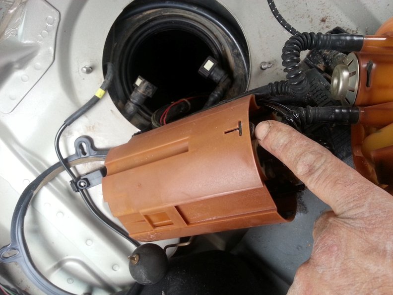 There are 3 tabs like this around the housing to press in and then pull the pump upwards