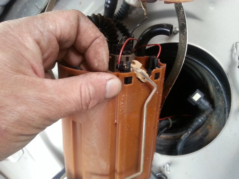Showing the 2 tabs to depress before removal of the sender resistor (press both in and pull up with pliers)