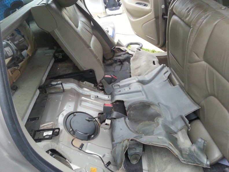 Sound deadening material peeled back and finally we can see the hatch.  Backrest is upside down in footwell