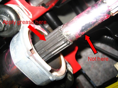 Apply grease to the splines on the upper end of the of the lower steering shaft.  Slide it out as far as you can without removing it from the upper column.  The photo shows red grease in the wrong place on the shaft because on my first attempt I tried to grease it without removing it first.