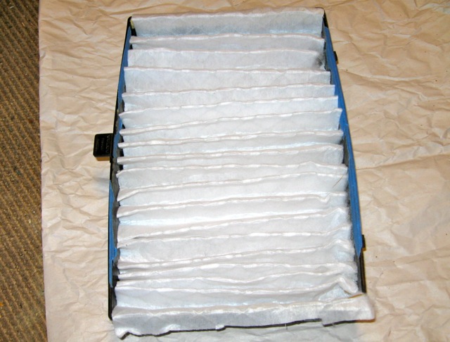 Fold up the pleats and place inside the frame with the wire side down