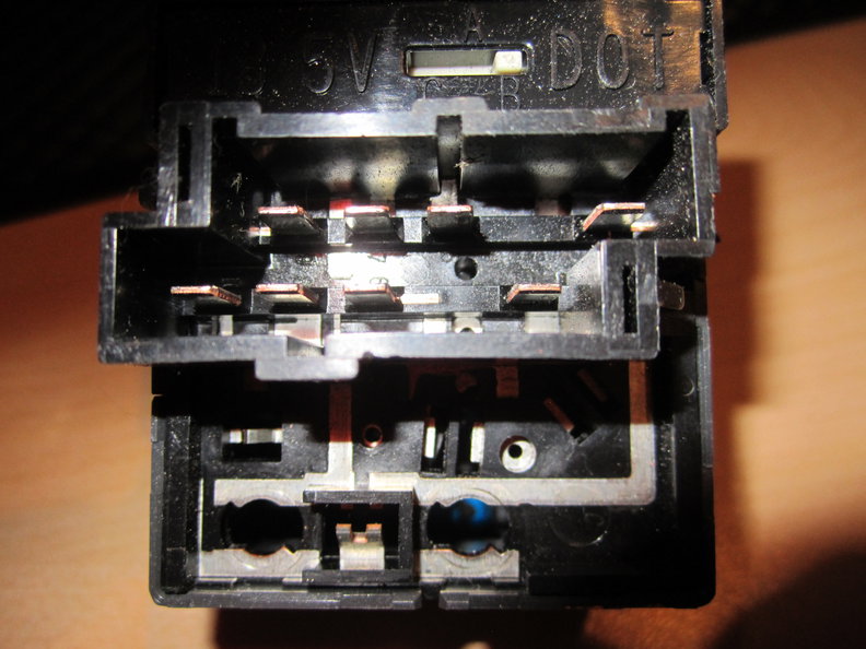Rear of headlight switch. Bulb slots at lower left of picture