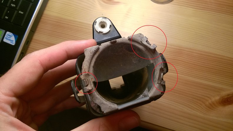 Tabs holding the lens.