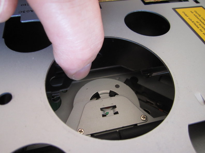 Push on metal plate below finger with spring on it forward