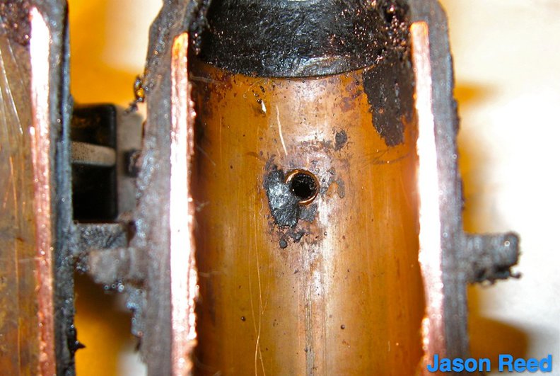 The small vacuum hole in the side of the copper tube