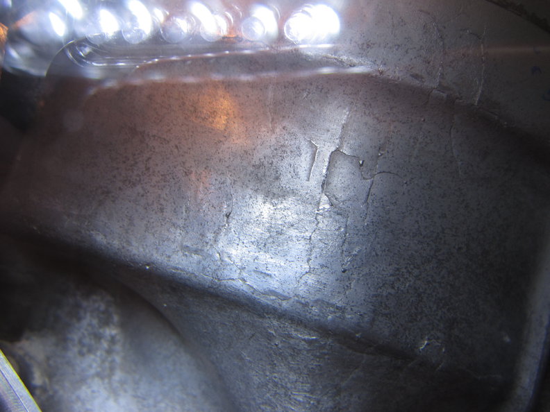 Indents or flakes missing from top of casing and spider cracks