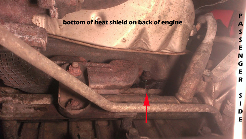 Laying under the car feet sticking out under the front mumper and looking up at the back of the engine.. passenger side