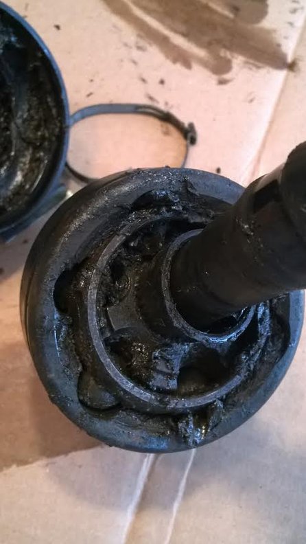 First opening of the busted cv joint.  Dirt embedded in the grease.  Tough to rotate.