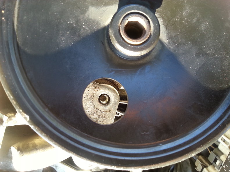 Now I'm stuck on this. This is the front, do you know which bolt runs through here to the bracket in the back? There are two of these holes I know they run through to the aligned holes in the bracket