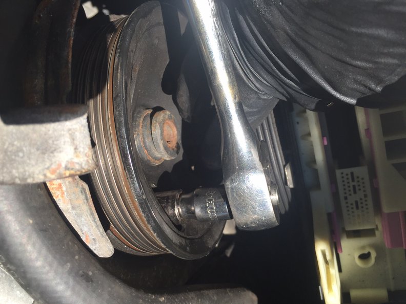 Removing 12mm power steering pump mount bolts, 3, through PS pulley