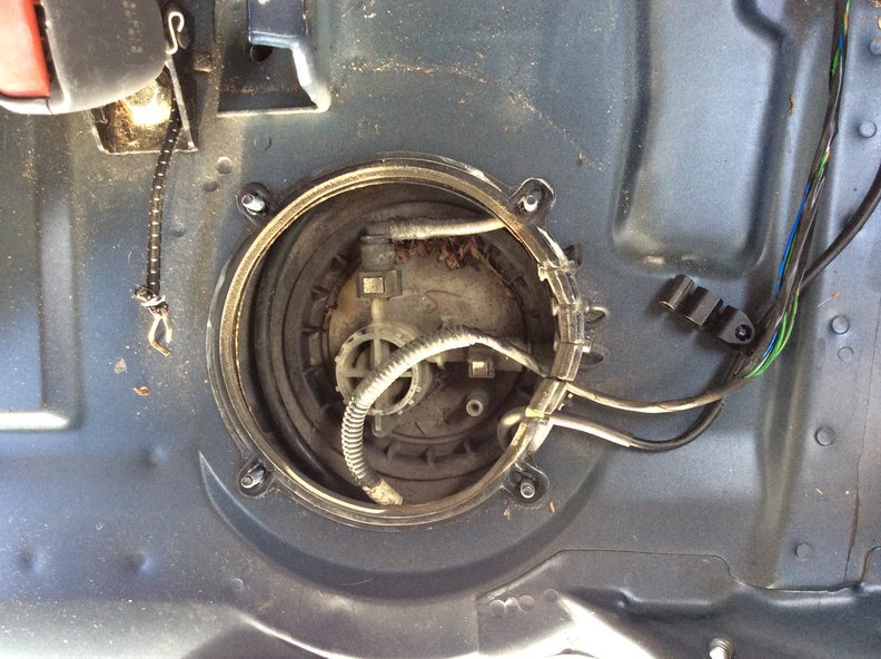 Under the passenger side cover