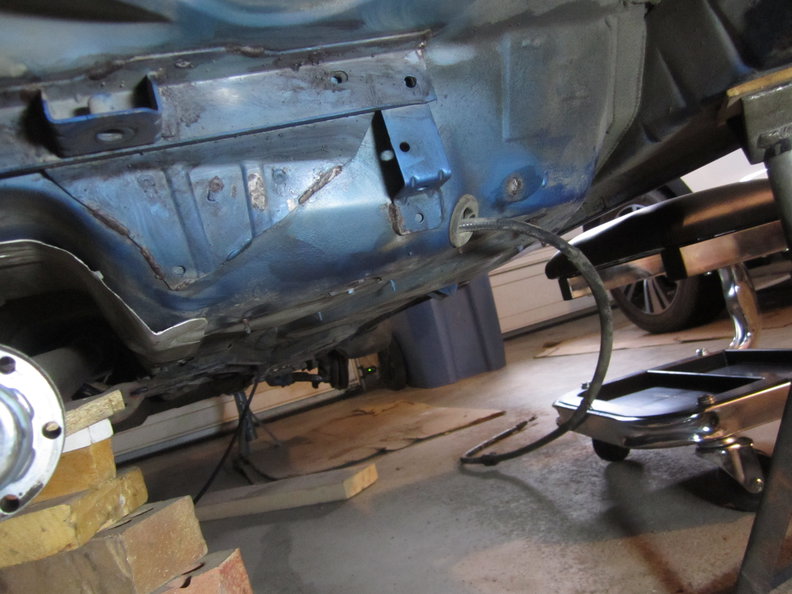 Rust behind passenger rear foot well