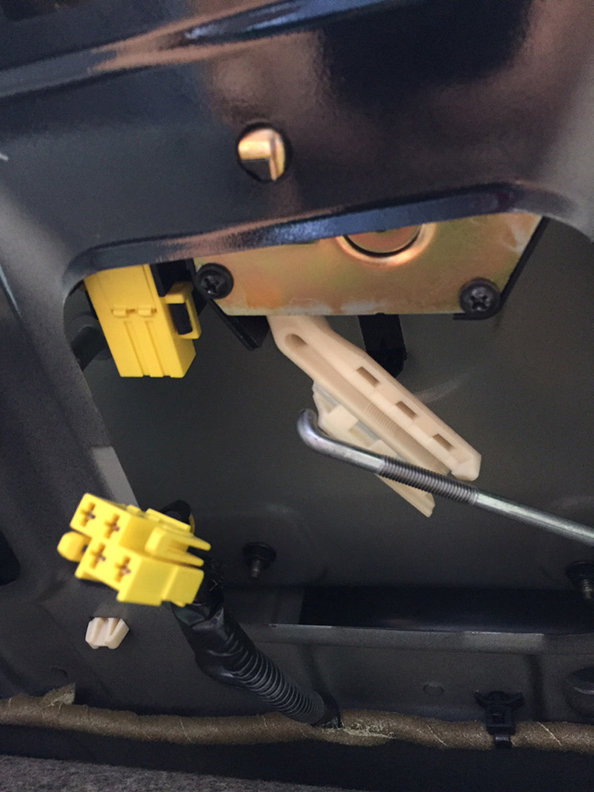 step 6 - once these are unhooked, you can remove the latch up and out of the trunk lid from the inside. In this pic it is sitting in the trunk.
