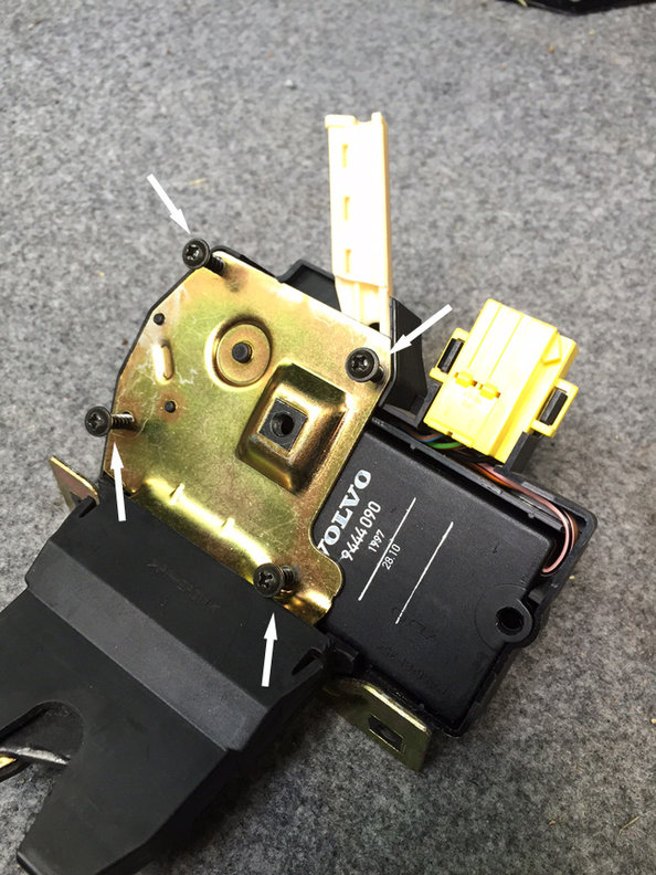 step 7 - remove the 4 phillips screws holding the latch assembly together. Once I did that I saw a broken spring sitting inside. At this stage be careful not to drop any parts or let the assembly fall apart completely. The latch isn't very complicated if it does, just a few levers could fall out/off but I like to keep things together on a quick job like this. If your car has a bad lock actuator, you can now remove the actuator from the latch and swap in another one.