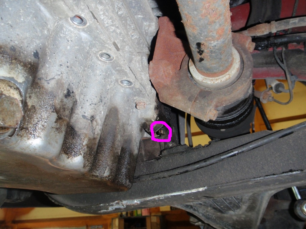 That circled one needs a combination wrench.  All others can be had with socket wrench and long extension.  The shiny section on the subframe is where the tab was cut away.
