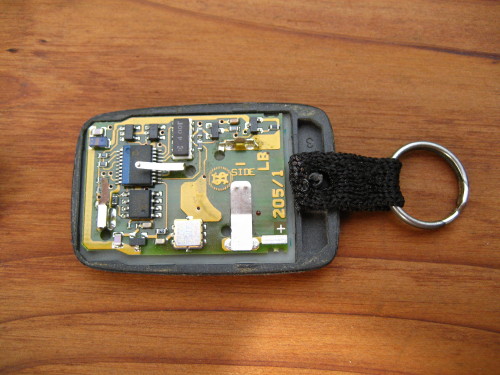 Place the webbing in the gap in the case with the plastic stud from the key fob poking through the hole in the webbing.