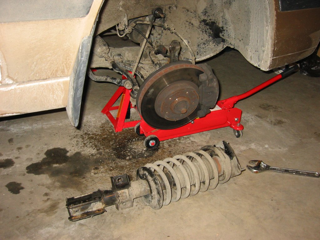 There is supposed to be a Torx hole that you can hold on to in the front of the sway bar link nut and undo the nut.  But sometimes the hole is rusted and cannot be used.  You can reach behind the nut and use a wrench to hold onto sway bar link bolt to undo the nut.  This is the part that took 40% of my total time because it was so hard to grab onto and so rusted.<br /><br />What you see in this picture is the sway bar link bolt, look closely, you see that its not a complete circle behind the bolt.  That's where you grab with a wrench.