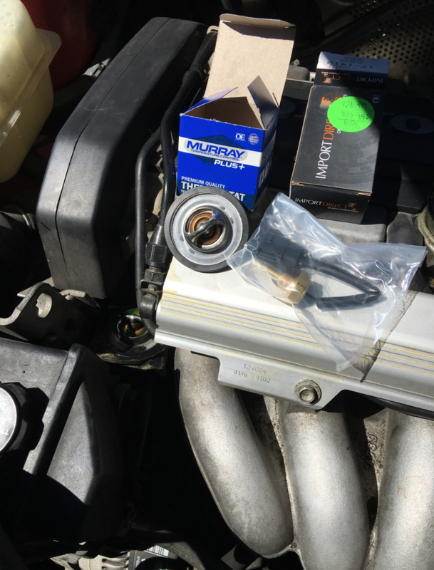 Thermostat cover off and ready to swap parts.