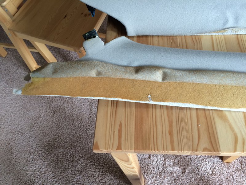 Peeled back fabric with foam residue on pillar.