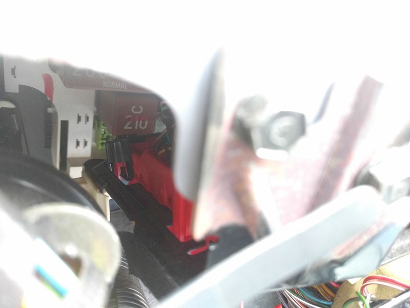 Peering over the top of the black mounting plate once the dashboard was removed.