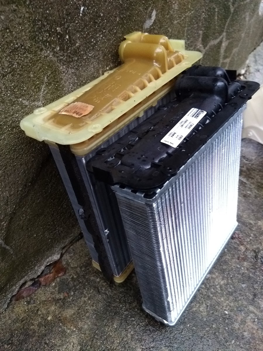 Old Volvo OE and new Nissens heater cores.