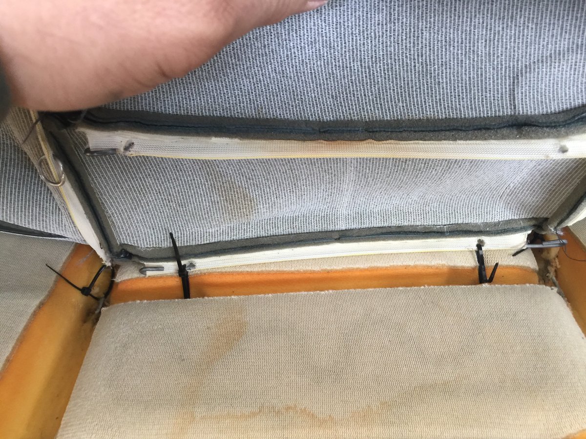 Tying in seat bottom cover to stays with zipties