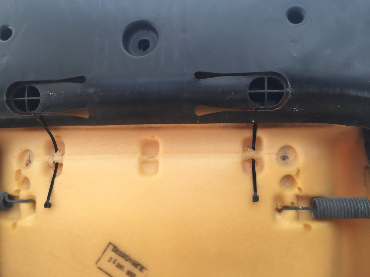 Start of seat back cover tie down, headrest release