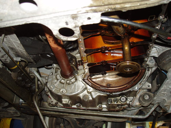 View of underside coated in oil with pan removed. Note that my RMS seeped for a very long time prior to it going completely. FYI - 90% of the oil you see happened in the last 35-40 miles it was driven, in which it puked out about 1.5 qts of oil.