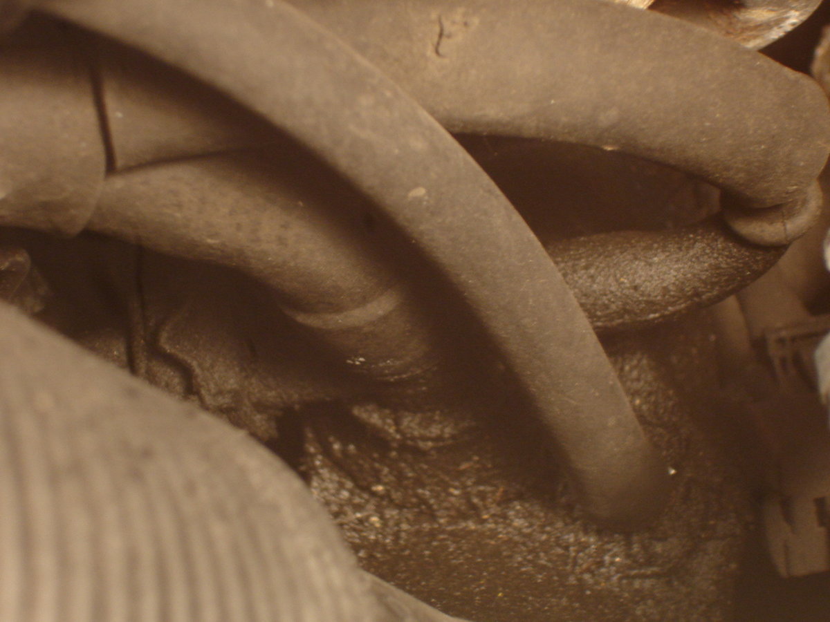 This is the actual location where the PCT attaches to the air intake. There is a hose in the foreground that I believe is not associated with the PCT valve.