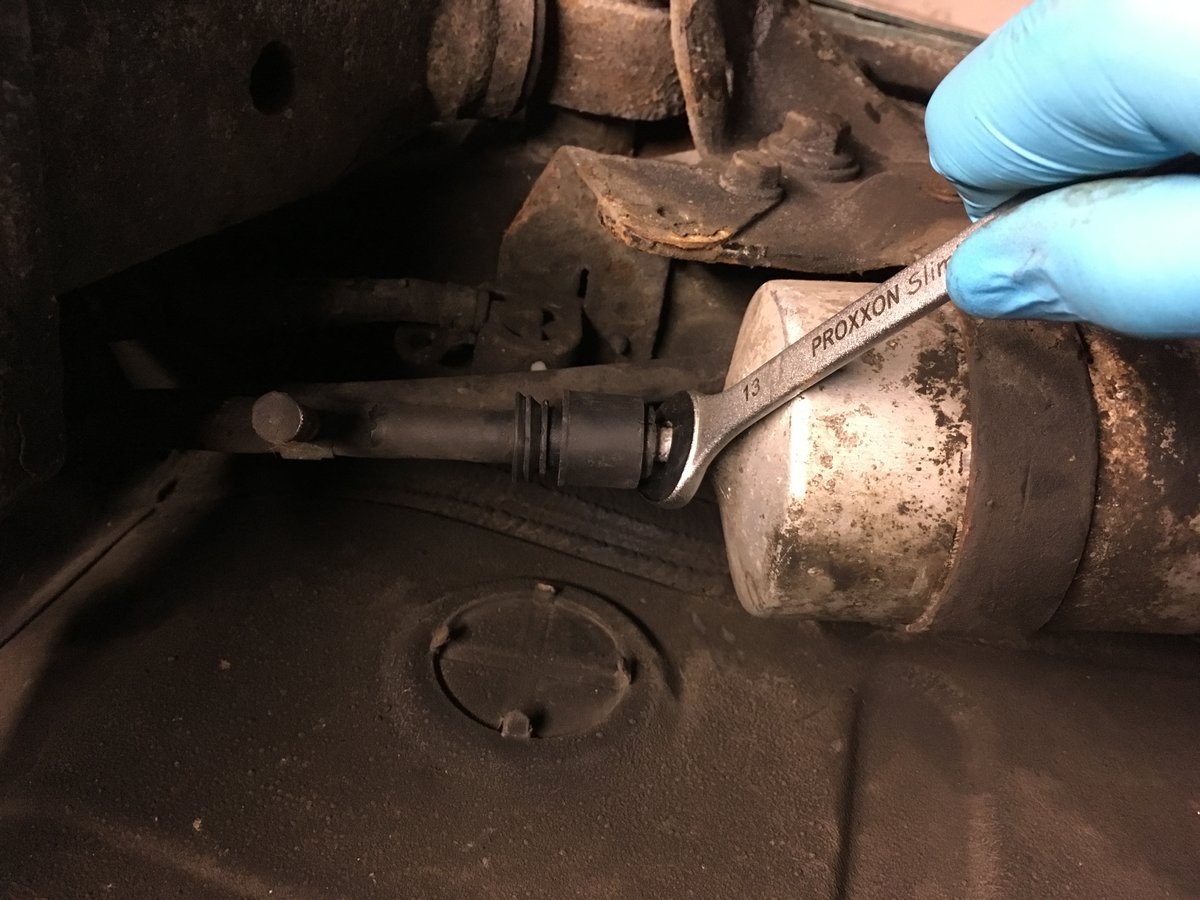 This is how I tried to undo the line, with more leverage than shown in the picture. I was afraid to snap my wrench, it was already bending a lot!