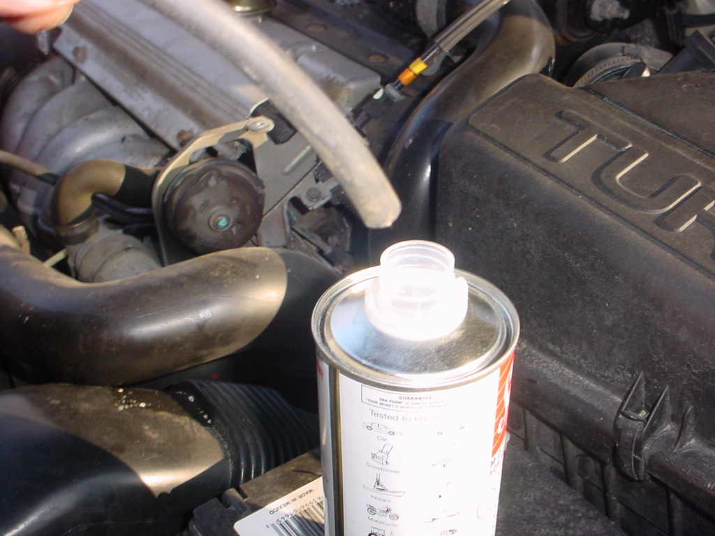 The open end of the added vacuum line to be used to suck in the Seafoam.