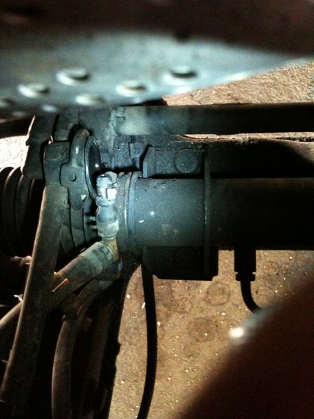 from standing in front of car looking down to the left axle