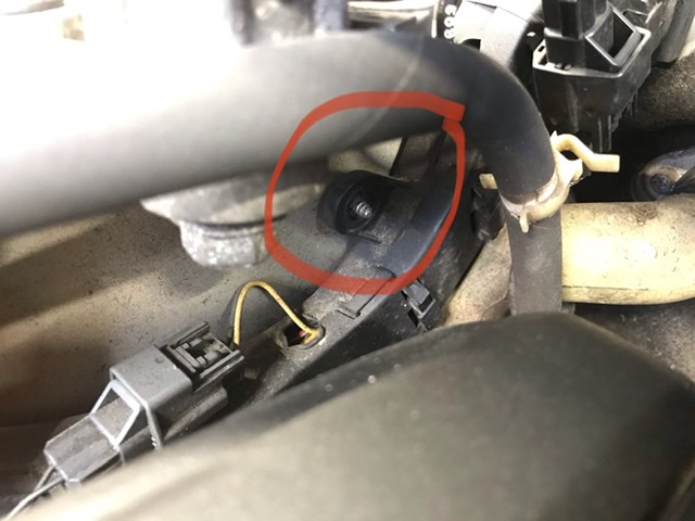 Plastic tabs which must be freed from side of strut tower to move wire loom