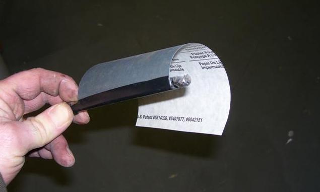 Honing tool made by taping a piece of sandpaper to a 1/4" drive socket extension.