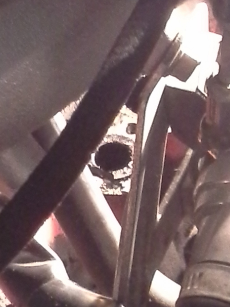 Broken PCV oil return hose in engine block