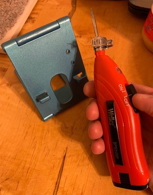 Soldering gun with tip held on with small cable clamp. Test piece right behind it. Takes a few seconds.