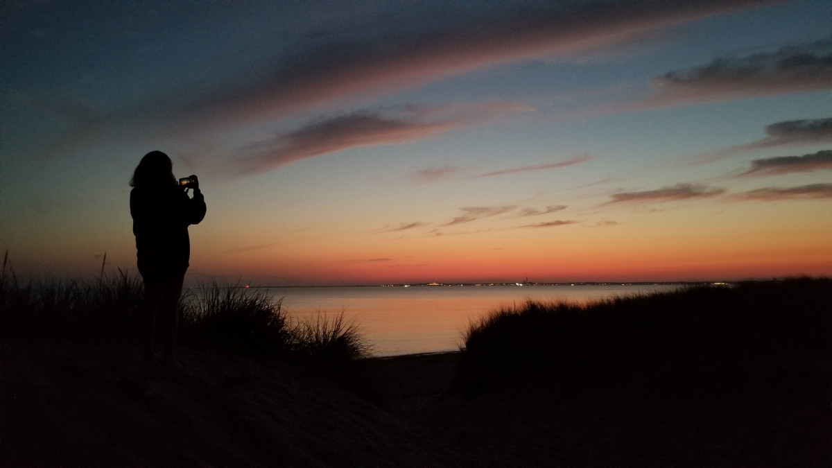 Taking a photo of the sunset while my daughter is taking a photo of the sunset, Provincetown in the backround