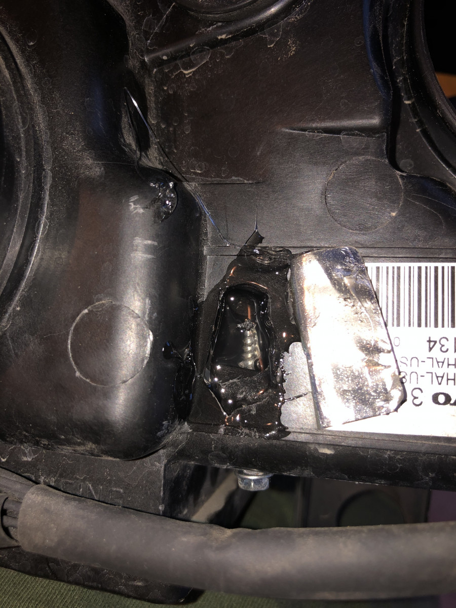 Clear Goop used to surround the screw squeezed in from back of frame