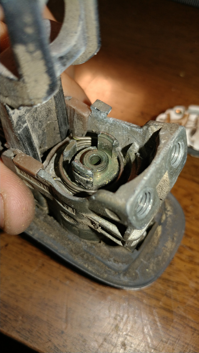 This is the MOST tedious part of replace process. Be sure to rotate the spring according to which spring arm will be loaded first. Insert rod assembly so first spring arm is loaded. You will need 1 or 2 tools to pry the spring arms back on the metal hook thing.