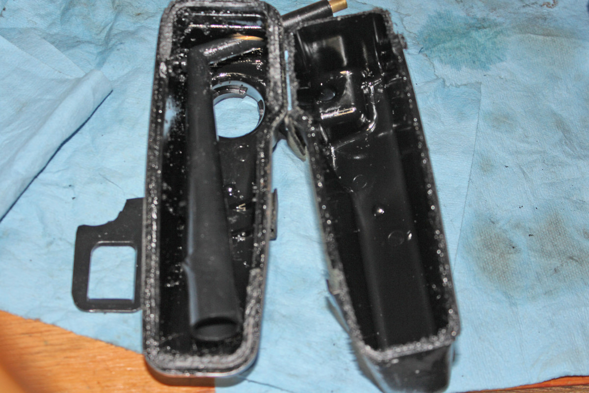 Broken piece pulled out and shown on side. Note the return line can pivot on the metal tube insert so end of the tube opening was at a higher position within the reservoir with the broken support piece.