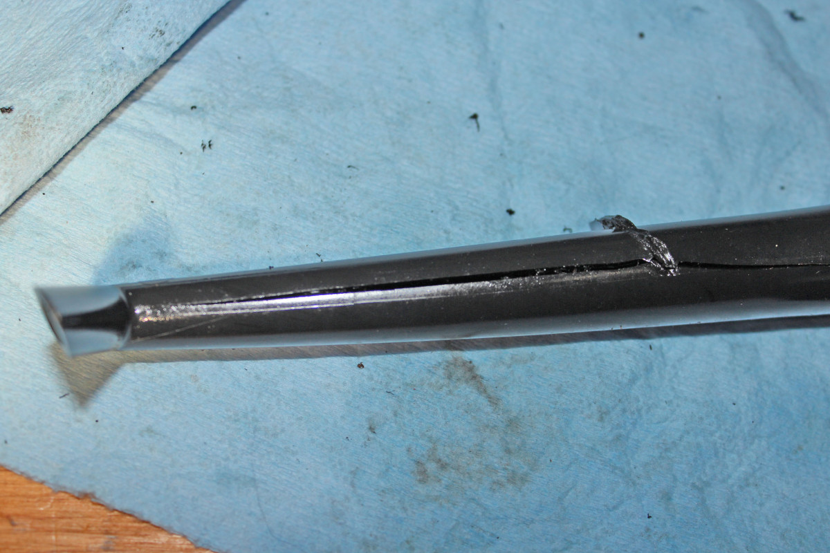 Crack in return line tube within reservoir.