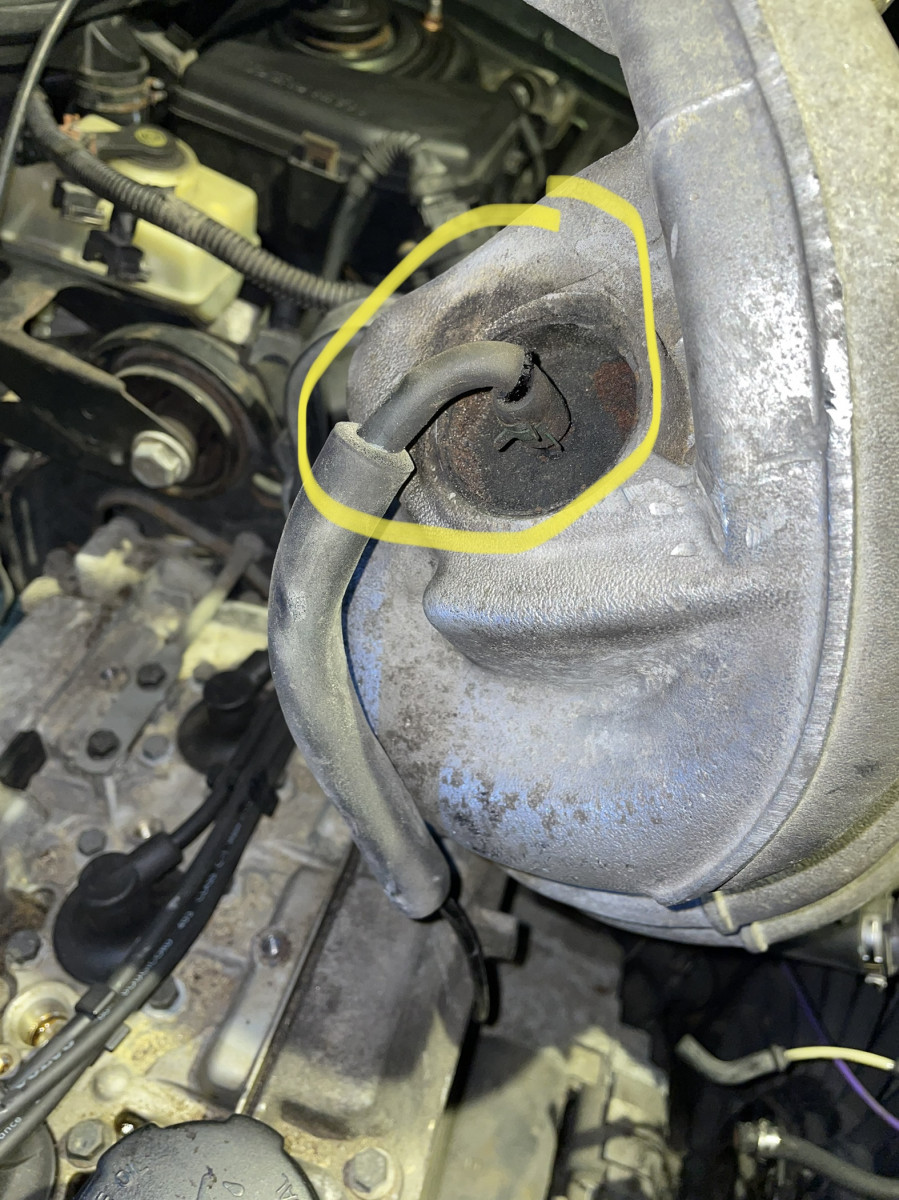 There is a crack by the elbow/bend of the hose (circled in yellow)