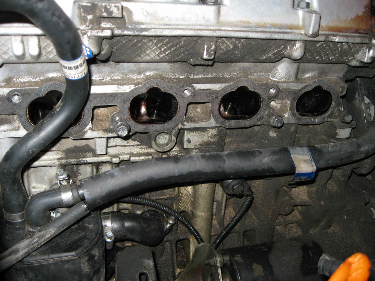 Just another view. It is puzzling that the bottom of the long PCV hose (i think it connects to the PTC nipple?) has oil on the bottom. It might just be the degreaser I sprayed in though. It doesn't look as wet as it would be if it was the source of all the oil.