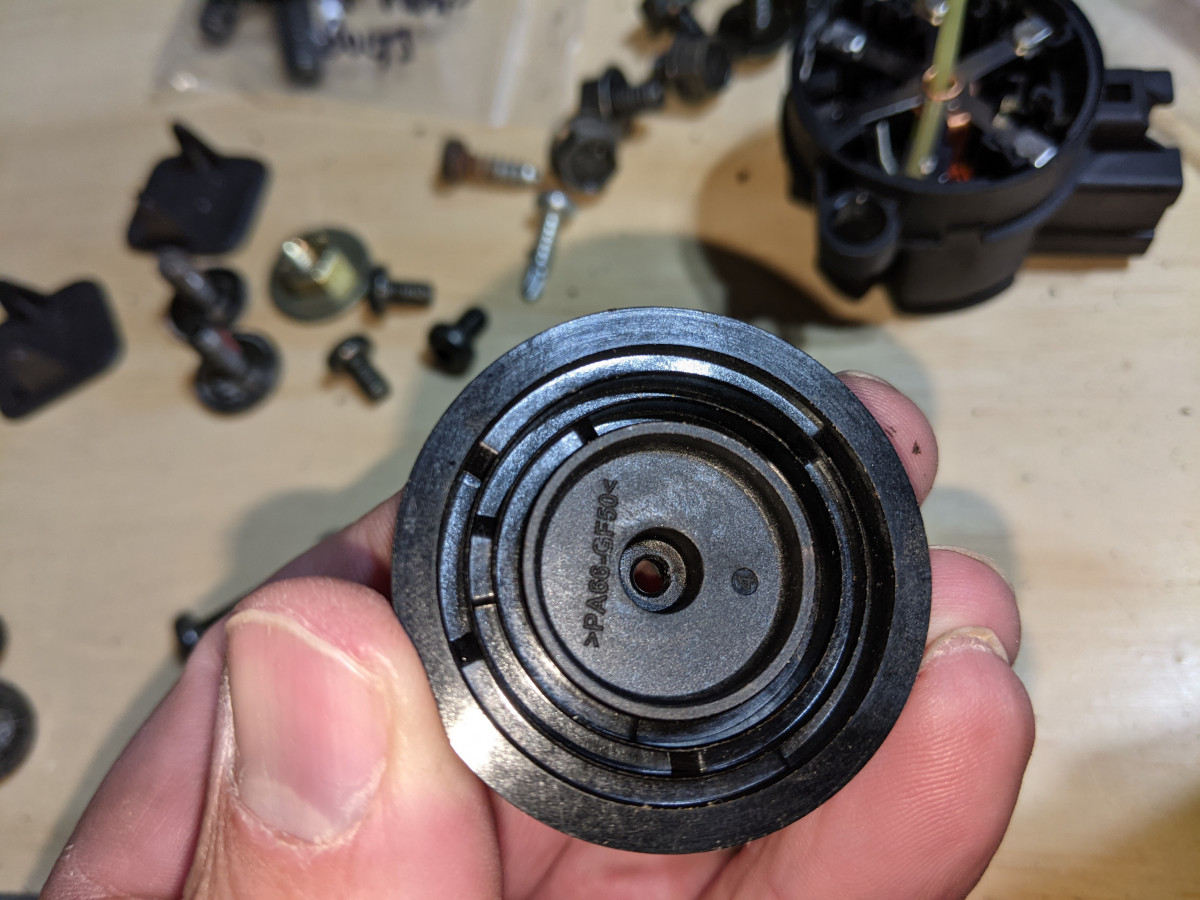 Cam cover lower side that pushes on the ivory sliders