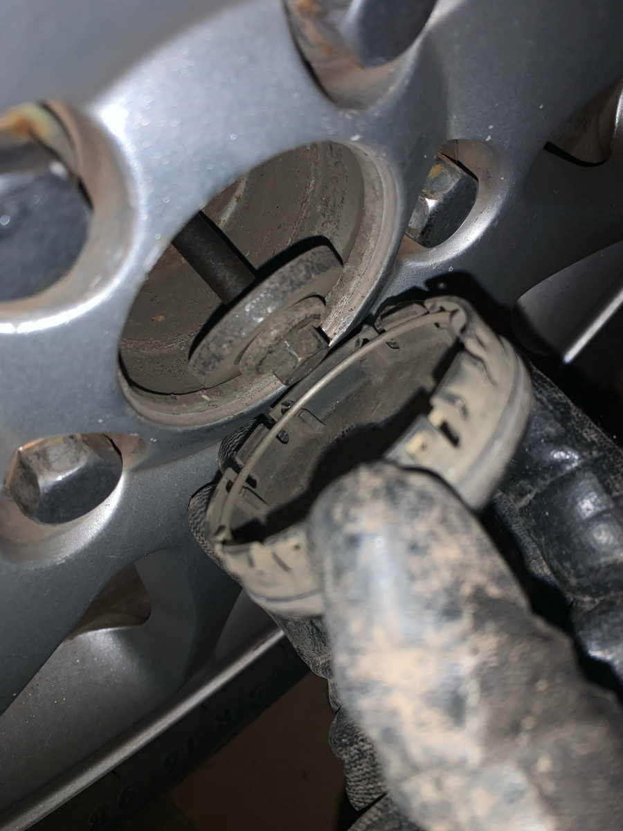 Driver's side front, under center cap