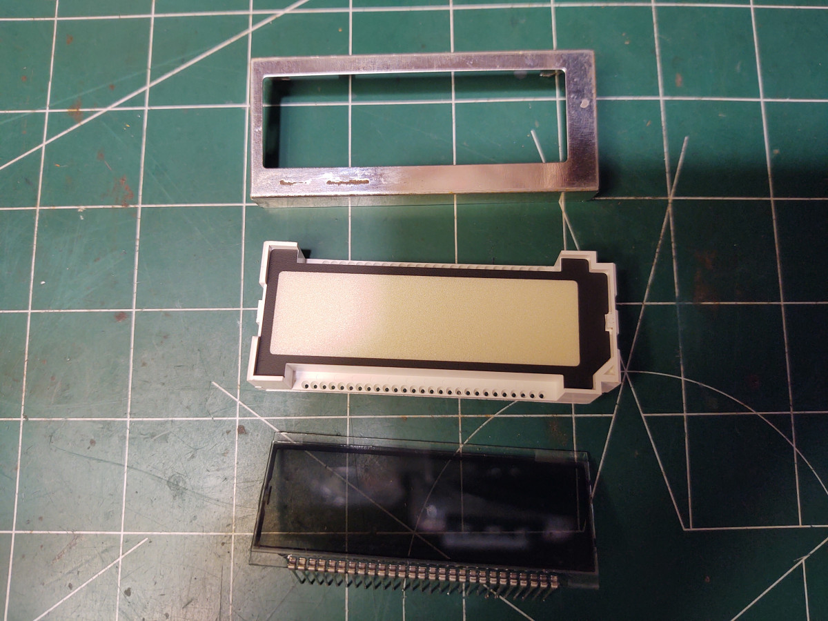LCD module, white plastic enclosure and metal frame