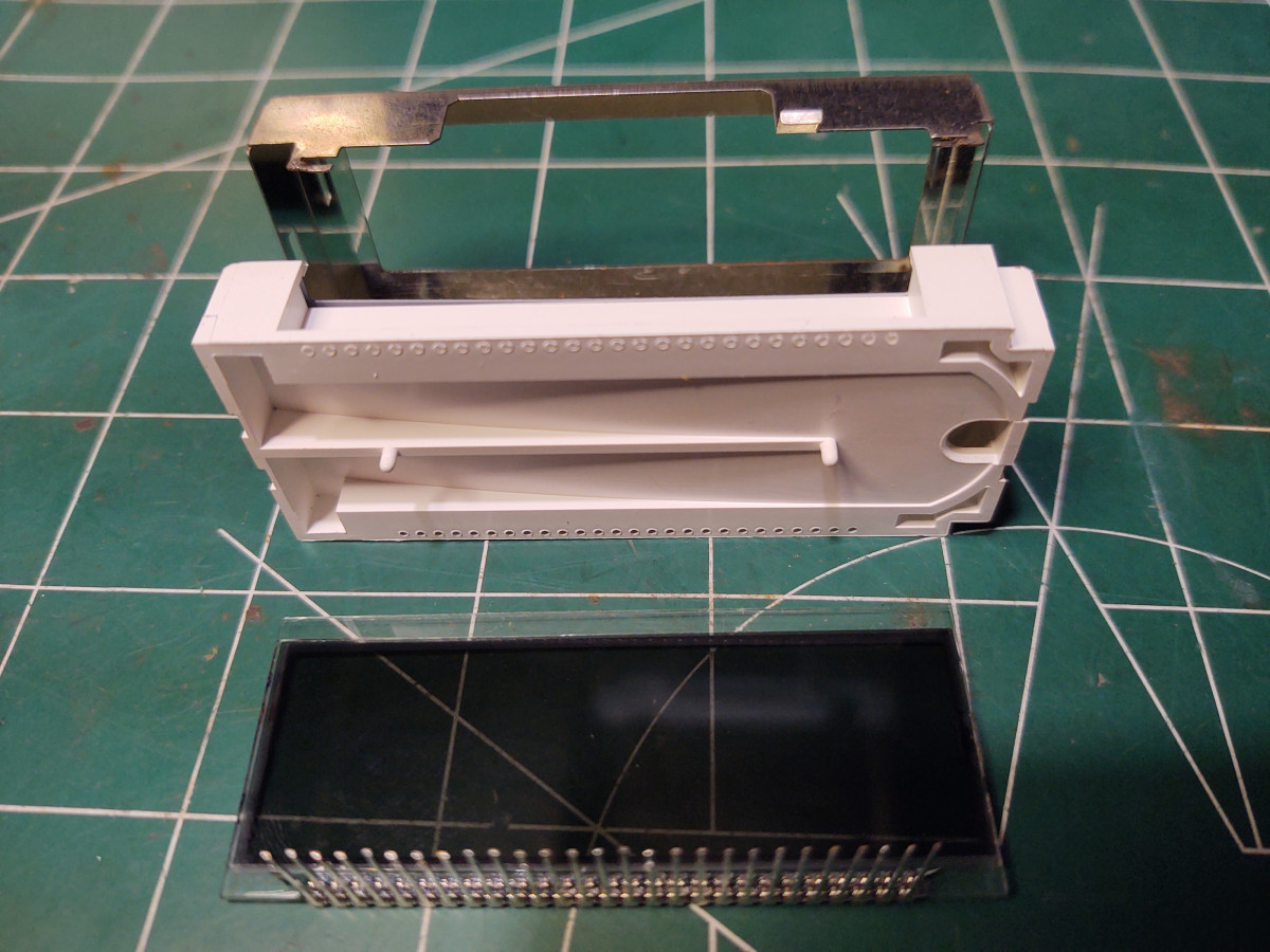 Another view of those LCD components; hole (RHS) under plastic enclosure for green LED.